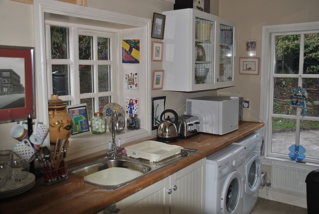 A utility room has a microwave, small fridge, cutlery, crockery and kettle for your use.