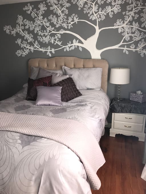 Beautiful lavender room with queen size bed and night stand