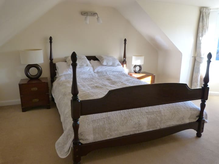King size upstairs bedroom. Another luzury sleeping space with 4 poster bed and classic campaign furniture.