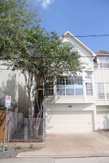 View of the house from the street. Staircase leading to second level entrance from gated area.