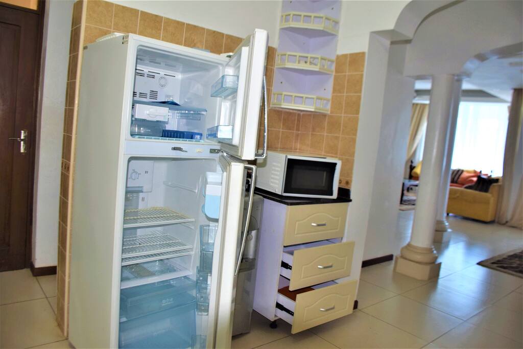 Fridge in the kitchen far off a sneek view of the living room