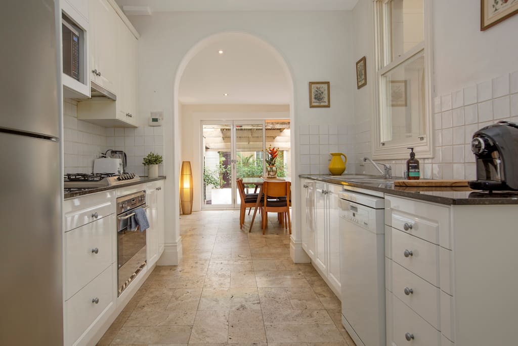 Bright Galley style kitchen leading to light filled dining & courtyard. Fully stocked with all appliances/pots & pans/ cutlery etc.
