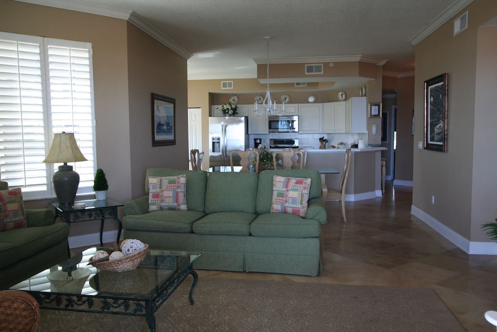 Family Room with 2 full couches and High Def Flat Screen TV and located with view of ocean with access to the oversized balcony.