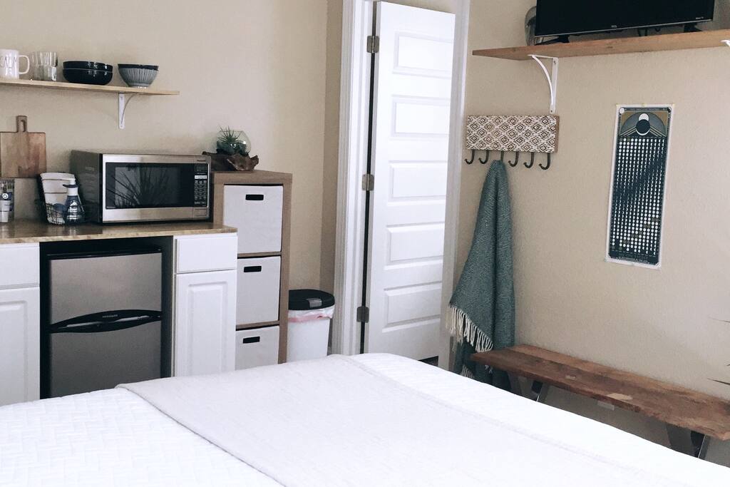Kitchenette in room with a microwave, mini fridge & Keurig coffee maker. Dish ware provided!