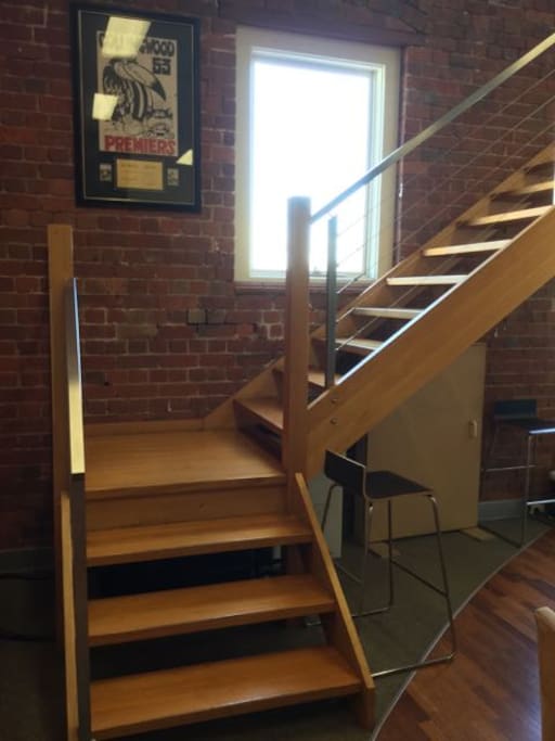Stairs to second floor where the desk is located