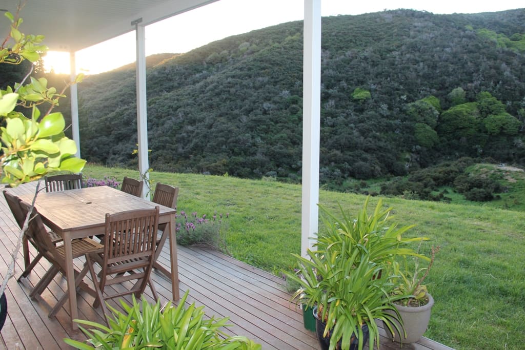 Tables and chairs on the deck at the front of the house