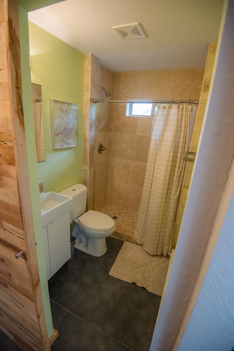 The bathroom is small but totally functional with a beautiful and large tile shower.