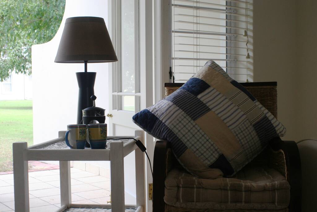 The comfortable lounge offers a couch and two armchairs and opens out on to the patio