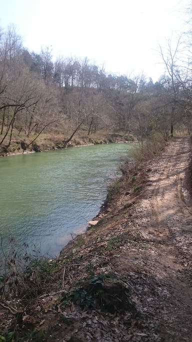 950 feet of river frontage with road, dock, cave, boats and more.