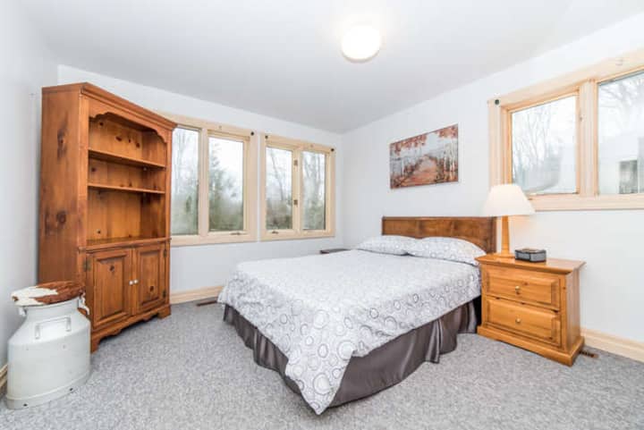 The fourth bedroom is full of windows,  overlooking the front and side of the chalet.  This room is equipped with a queen size bed.