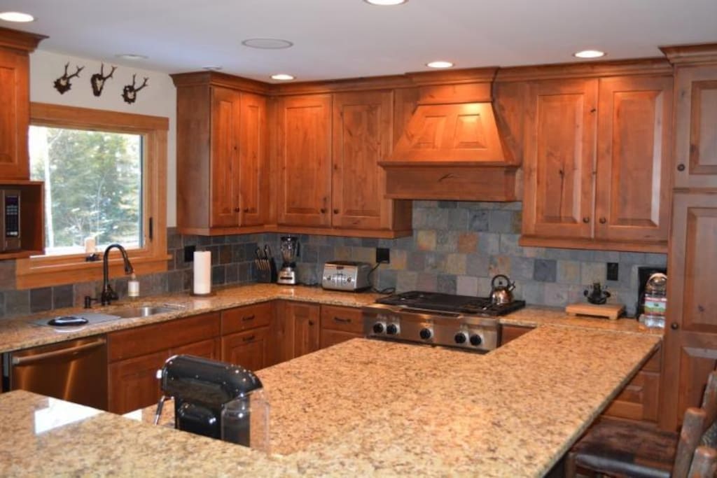 Kitchen area, 26 inch dual fuel range, Nespresso machine, Keurig, coffee machine, much more.