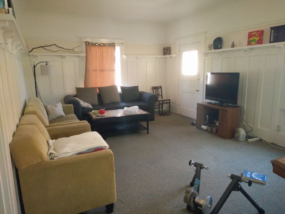 Living room with 3 couches and TV