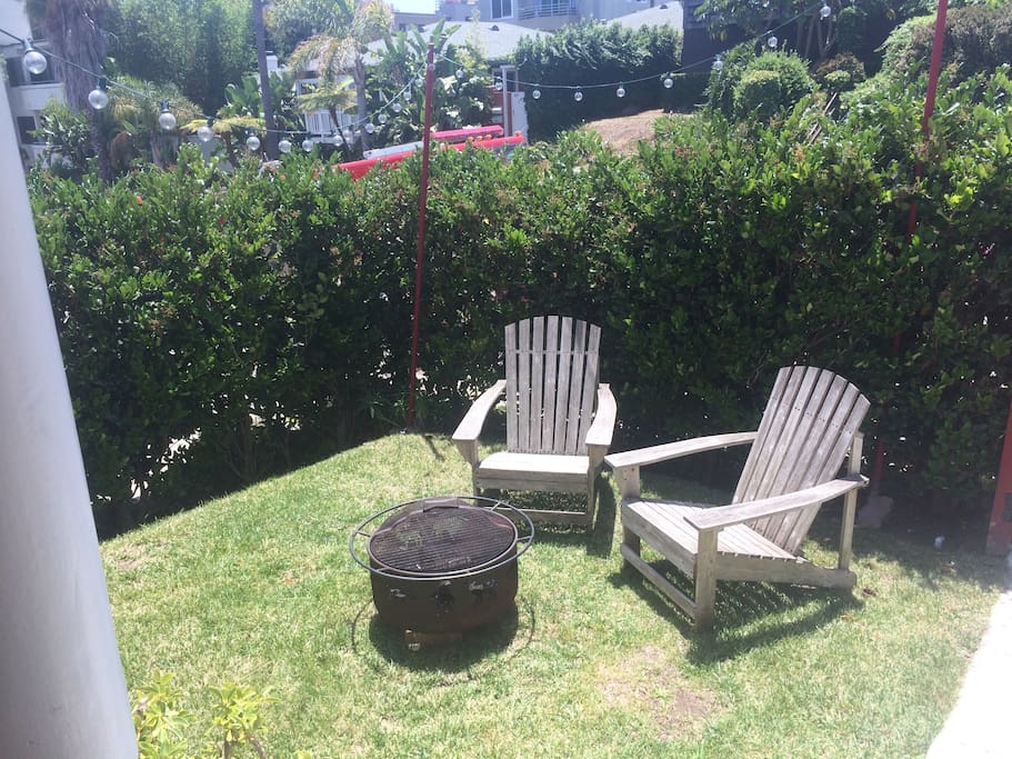 front yard has chair and a fire pit