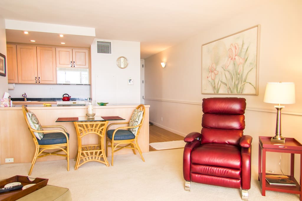 Dining table, recliner chair. Note, carpet replaced with bamboo wood.