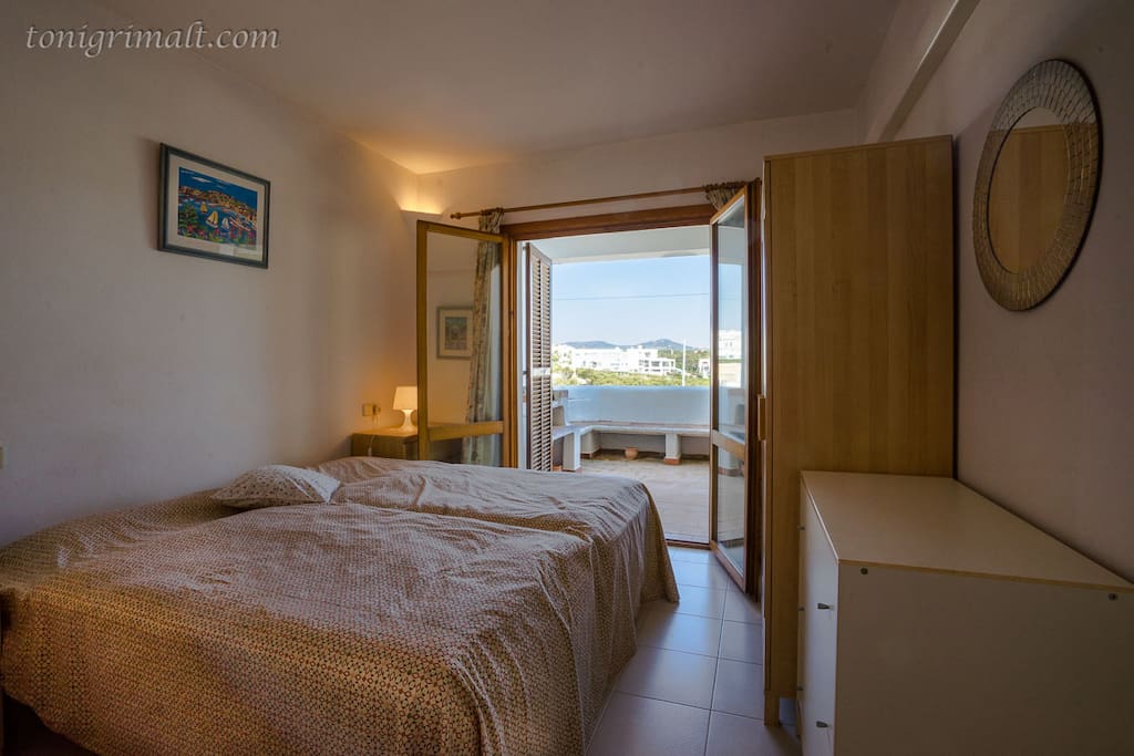 Main Bedroom ( 2 - single beds) with door to Terrace and sea/harbour views.