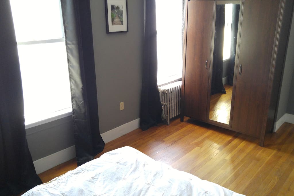View from the bed. Wardrobe has full length mirror. Access to 1/3 (left door) for clothes. Hangers available to use.