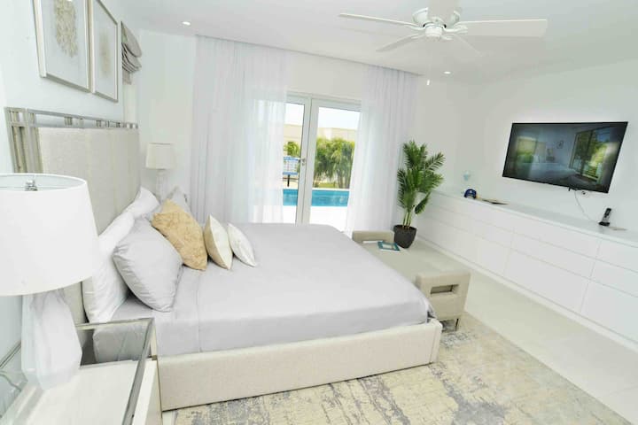 Master Bedroom with direct access to the pool deck and private entry.