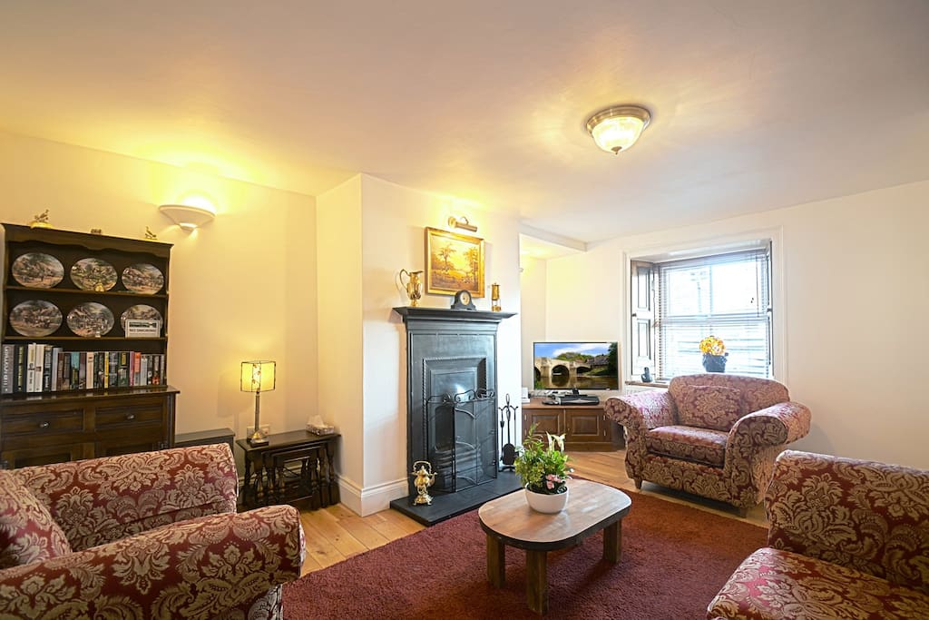 The Living Room in Riverside Cottage features a character open fire, 40" LCD TV and DVD Player and comfortable seating for four people.