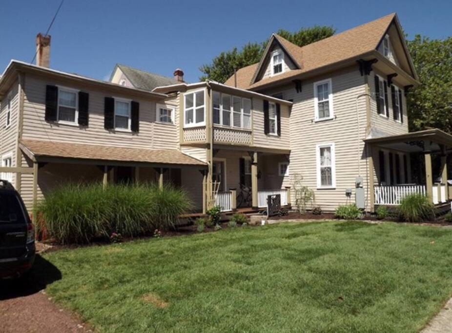 Side of house - garage (with pool table inside), driveway fitting 2 cars and patio (with table, chairs & BBQ) to left of this photo