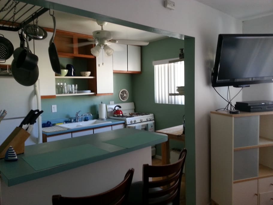 full size open kitchen with gas range full size frig and eating area
