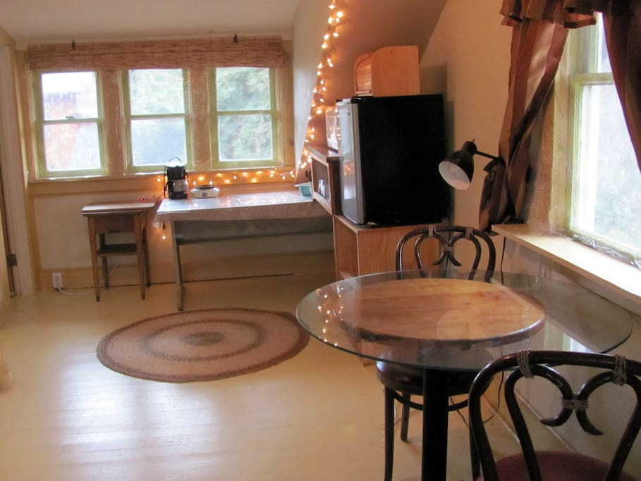 simple kitchenette with cafe-style table, nice view out the west window