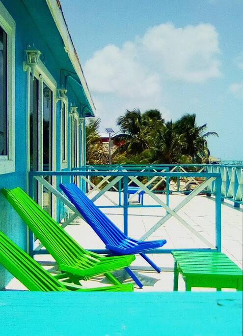 Sliding doors open to a spacious shared veranda (partially sectioned off for each Room) with deck chairs provided to sit and bathe in the abundant tropical sunshine :)