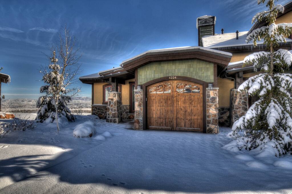 Home Front-Winter with Flat Driveway and Single Car Heated Garage