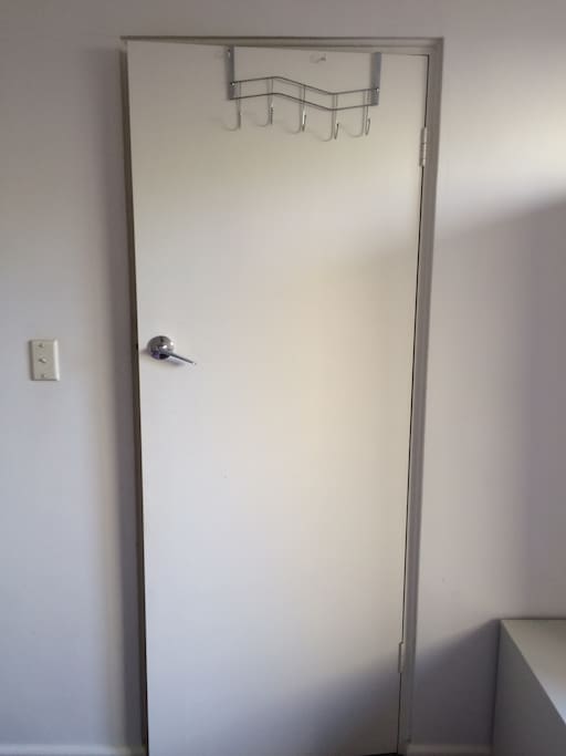 a hanger to hang your towels behind the door