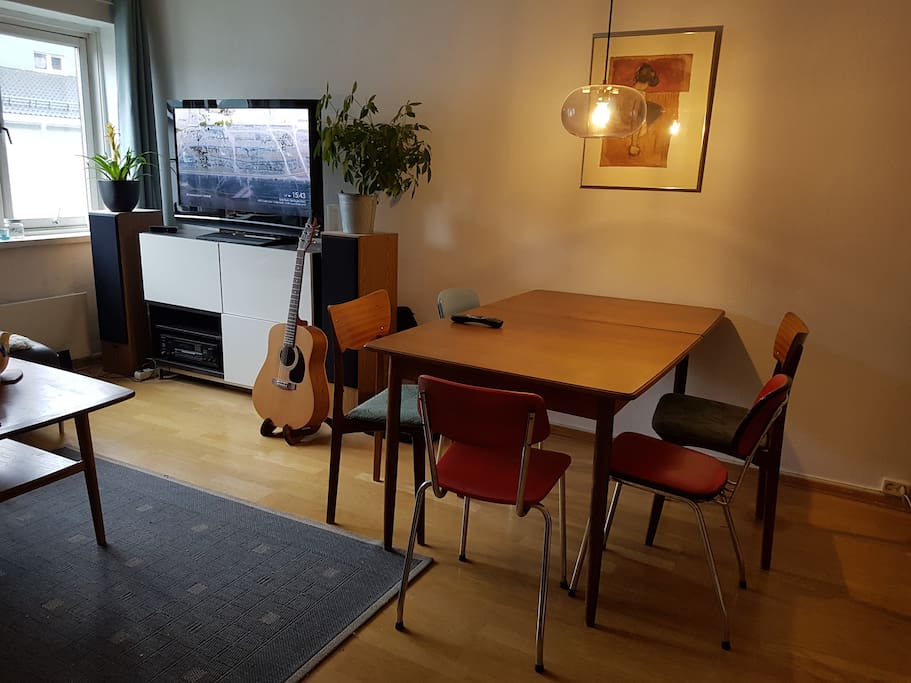 The living room offers a sofa section as well as dining table.