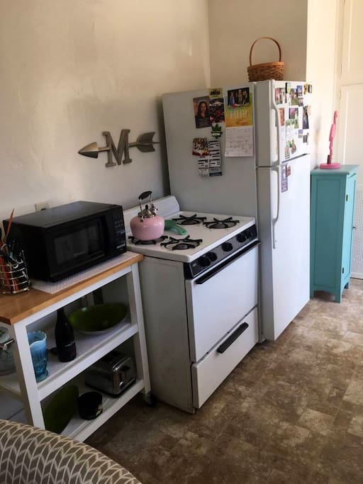 Kitchen with fridge, stove top cleaner oven, microwave, toaster, and Keurig