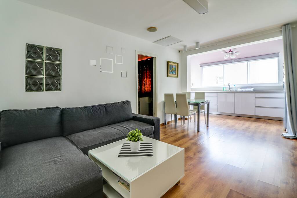 Living room, dining table, entrance to the bedroom.