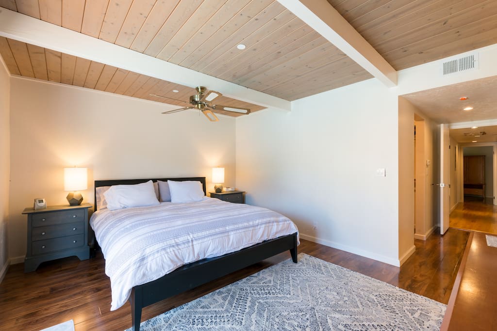 master bedroom w/ cal king bed and french doors to backyard