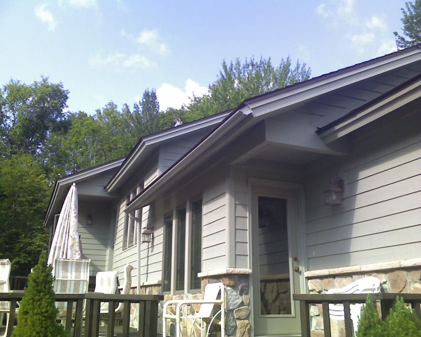 back of house with deck