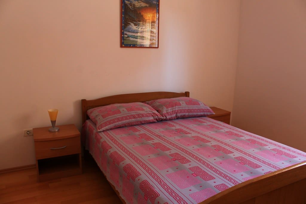 A large double bed and large closets in the bedroom.