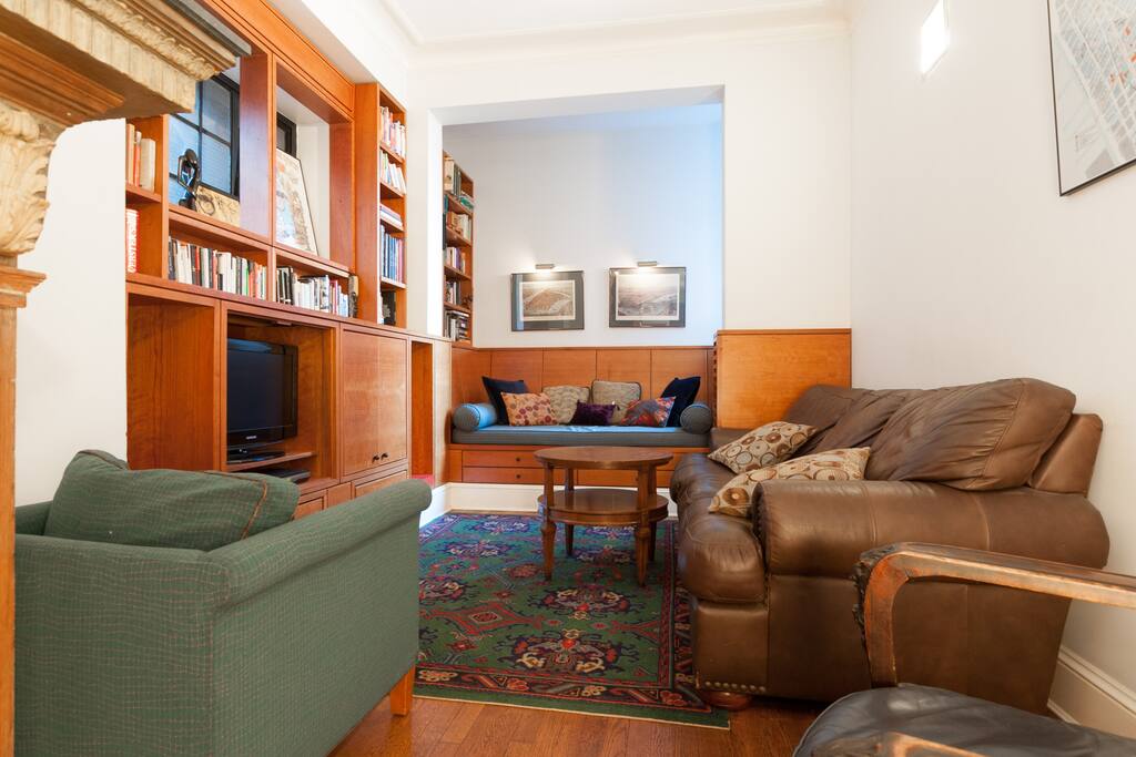 Living room/library with cherry wood, tv and fireplace