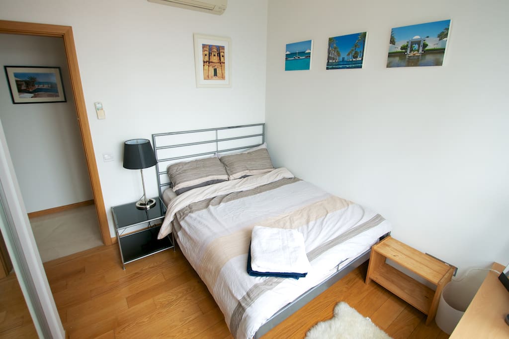 Guest room with comfortable double bed and fitted wardrobes