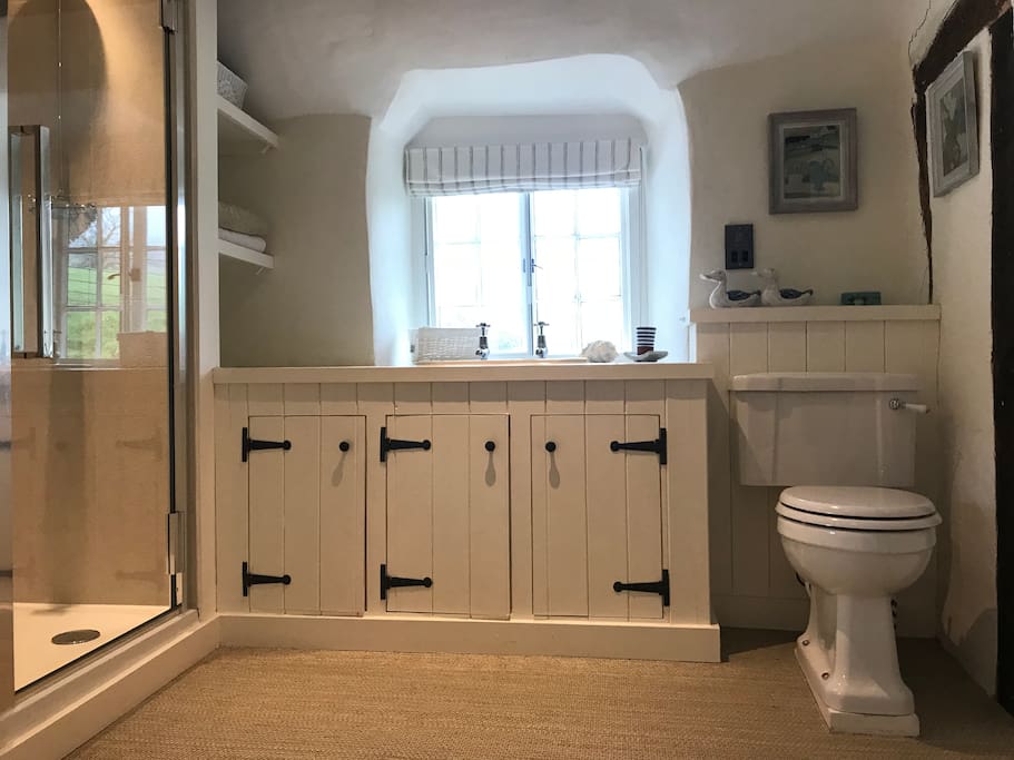 Huge bathroom with cupboards, bath and separate shower