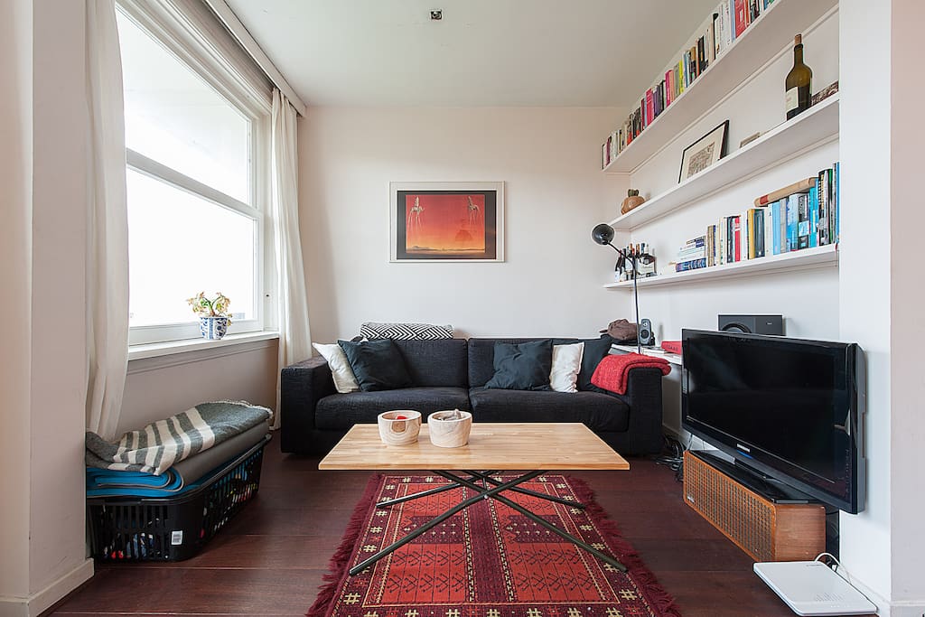 The bright living room and nice view over the comfy couch.