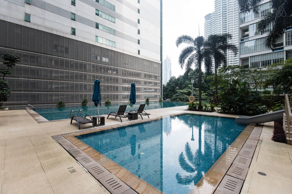 Large swimming pool and children's pool with a view of KLCC