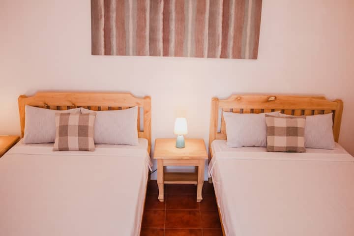 Bedroom 2
- Air Conditioned
- Sleeps up to 5 people
- 2 double beds, 1 floor mattress
- 1 AC unit
- Wardrobe and cabinets for storage