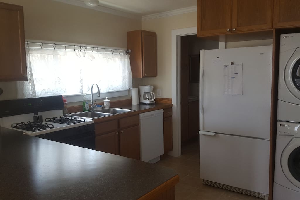 Immaculate, roomy kitchen with everything you need, including a full-size washer and dryer