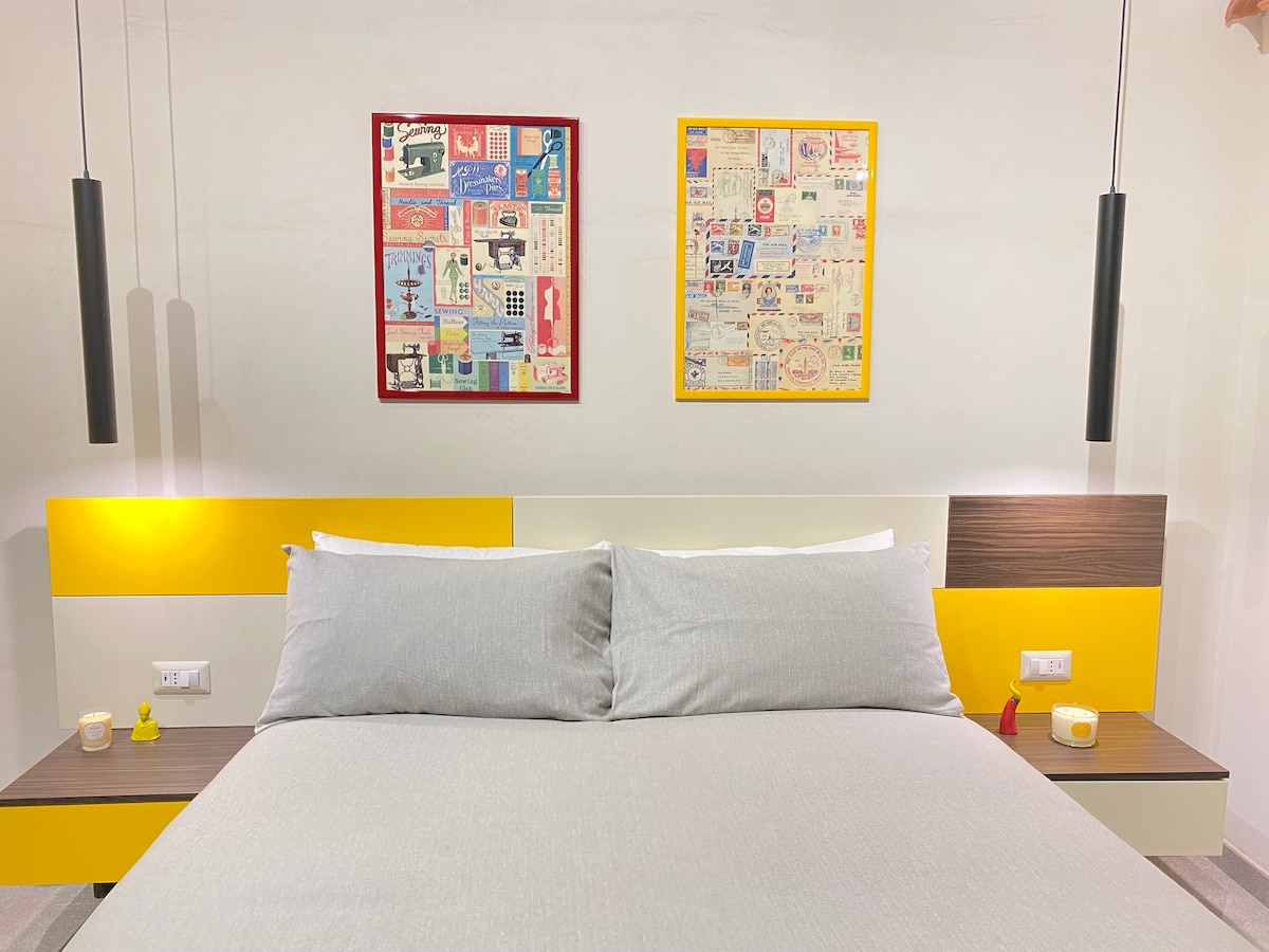 Krevat dopio i rehatshëm në një dhomë gjumi me dritare. 