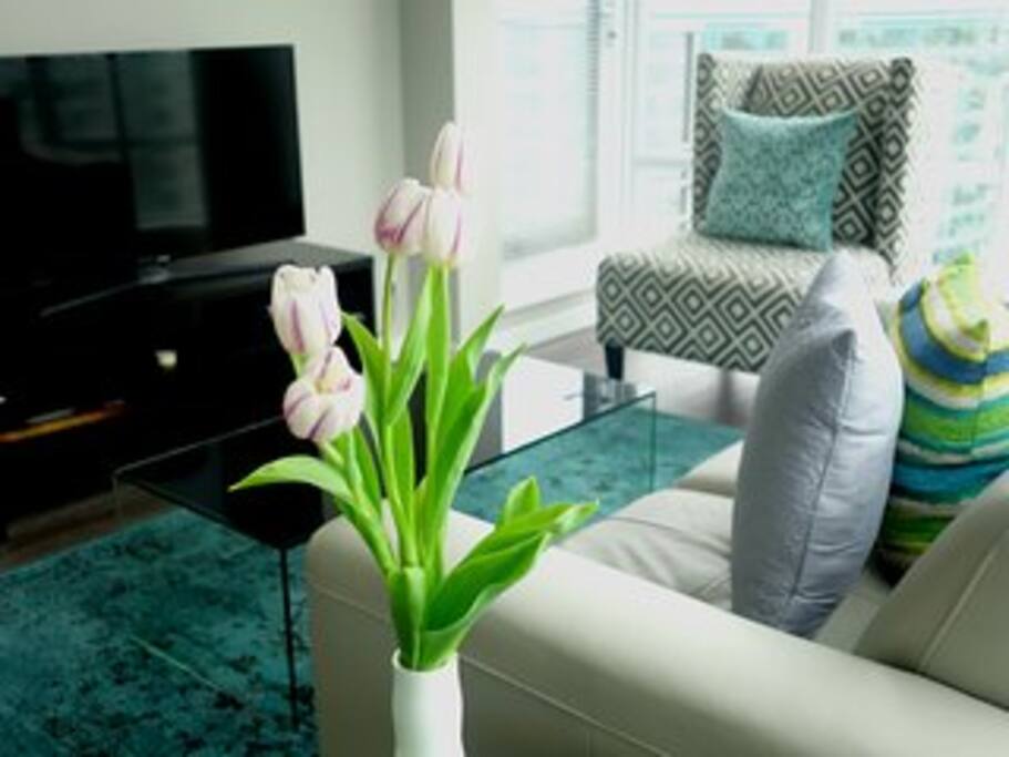 Living space with stylish accent chairs and leather love seat in a bright space