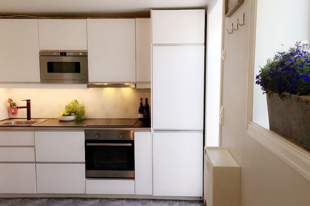 New kitchen, installed in 2015. Microwave, oven, induction-top plates, fan, freezer, fridge - Large freezer/fridge. We provide (1) dishwasher tablet for each day of you stay, and complementary coffee/tea for your breakfasts.