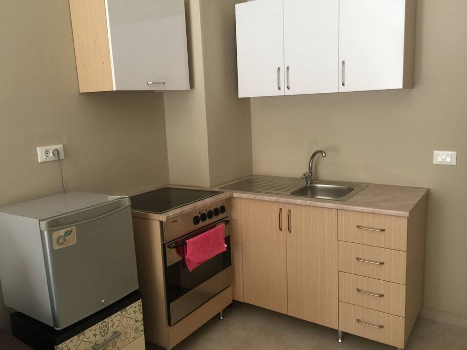 Kitchen with a oven and fridge.