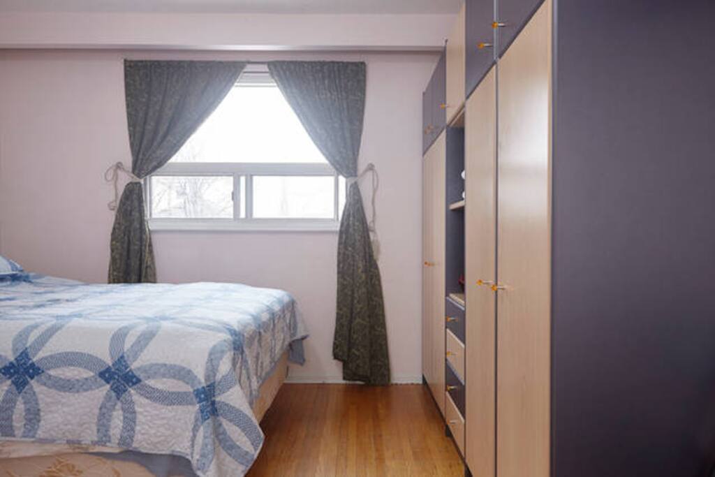 A comfy Queen bed and a large bright window