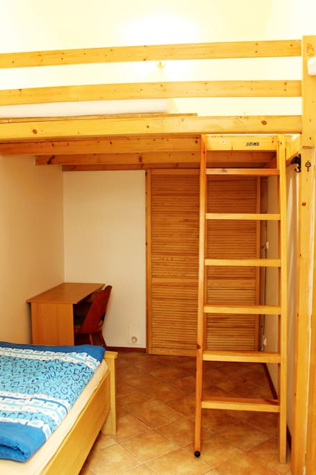 Bedroom 2 with single bed on the floor and double bed up the ledder.