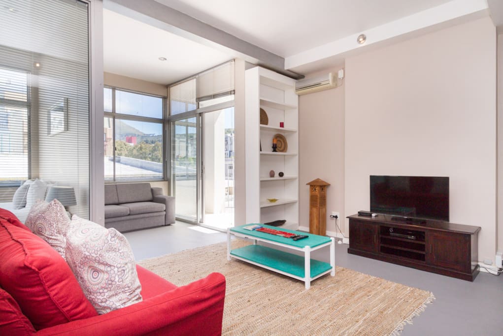 Lounge with a comfy sofa, flat screen LED TV and full DSTV Premium Package.
