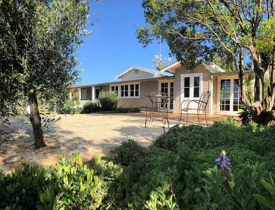 The Villa is surrounded by a hedge with rustic iron gate and Mediterranean style gardens including a culinery herb garden