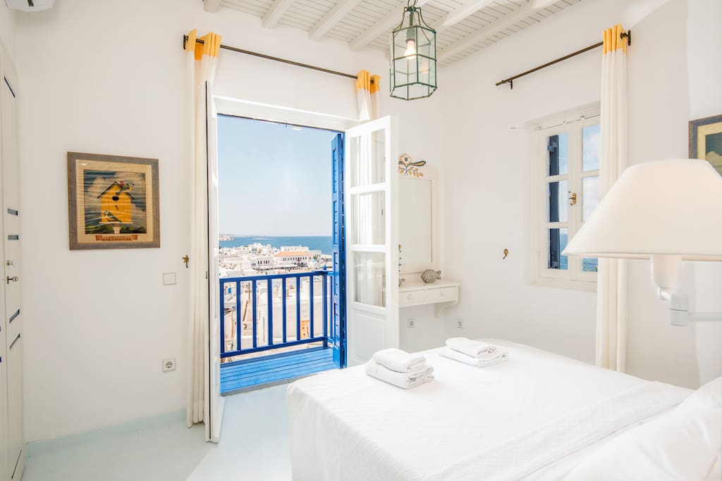 The first bedroom with spectacular views to the town of Mykonos, Delos island and the sunset